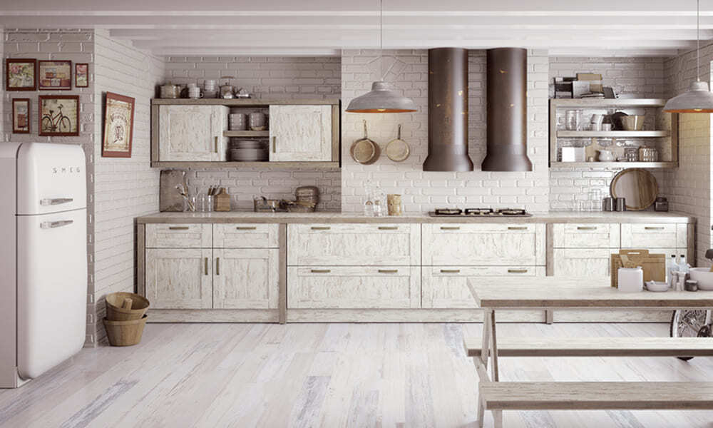 Os acabamentos wheathered look como a pintura distressed e shabby chic nas madeiras ou o equivalente nas infraestruturas em metal como a aplicação da técnica patina nos exaustores são algumas das mega tendências para cozinhas em 2020. cozinha em madeira